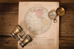 Image of vintage map, compass, and binoculars.